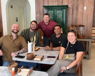 group of Coder employees sitting at a table